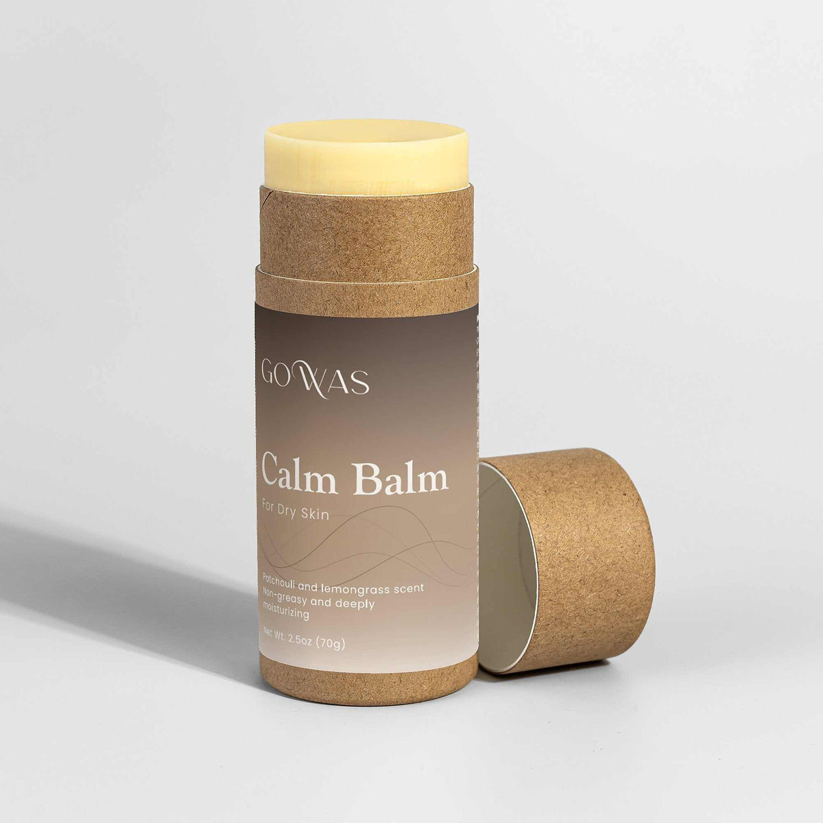 Calm Balm moisturizing stick with a brown label, natural cork casing, and pale yellow balm visible at the top