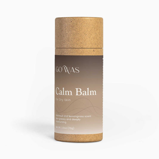 Calm Balm moisturizing stick with a brown label and natural tan cork-like top and base, in a cylindrical tube