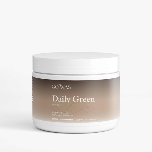 Daily Greens powder supplement in a white plastic jar with a beige label and white screw-top lid