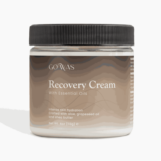 Recovery Cream in a clear plastic jar with a black ribbed lid, beige-brown wavy label, and white lettering