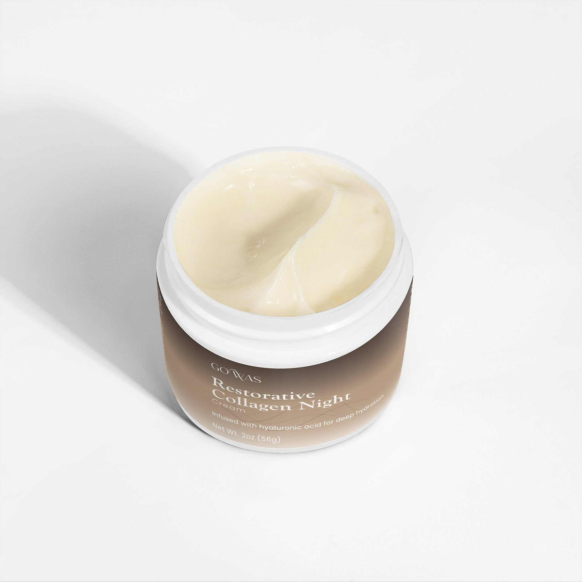 Restorative Collagen Night cream in a beige jar with a white rim, showing smooth pale yellow cream inside