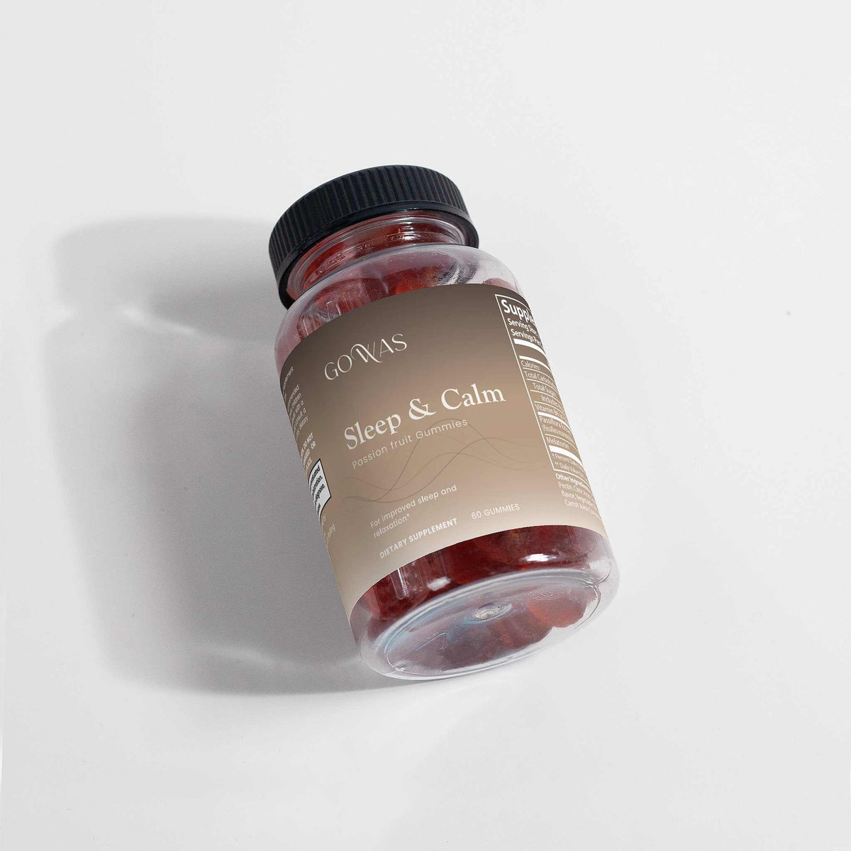 Sleep & Calm supplement in a clear bottle with a black cap, amber gummies, and a beige label with white lettering