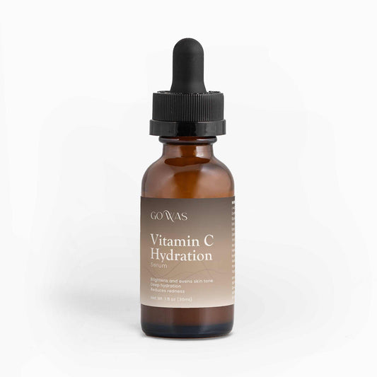 Vitamin C Hydration serum in an amber glass dropper bottle with a black pipette cap and tan label